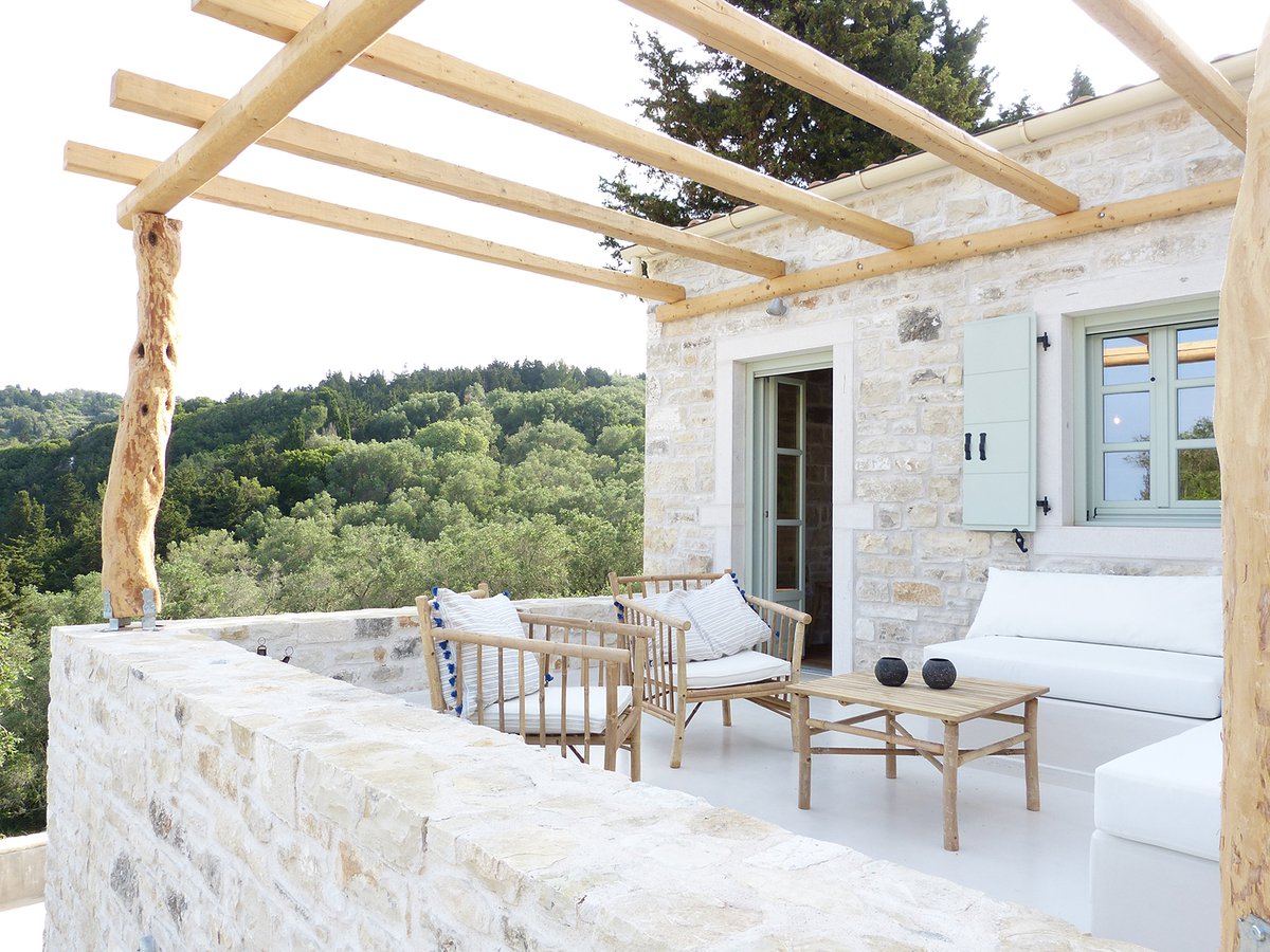 Patroclus rental home in Paxos, Greece. The home is decorated with bamboo dining furniture.