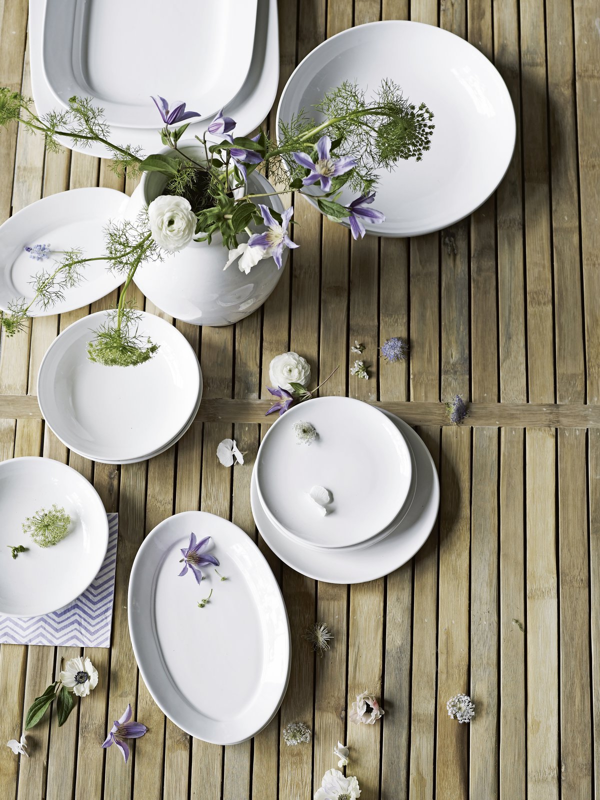 Easter table setting with fresh flowers and white ceramic - bring Spring to your Easter table