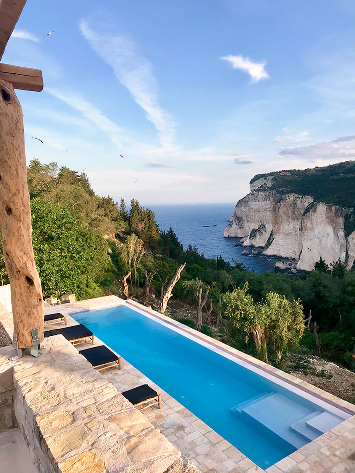 Patroclus rental home in Paxos, Greece. The home is decorated with bamboo sunbeds.